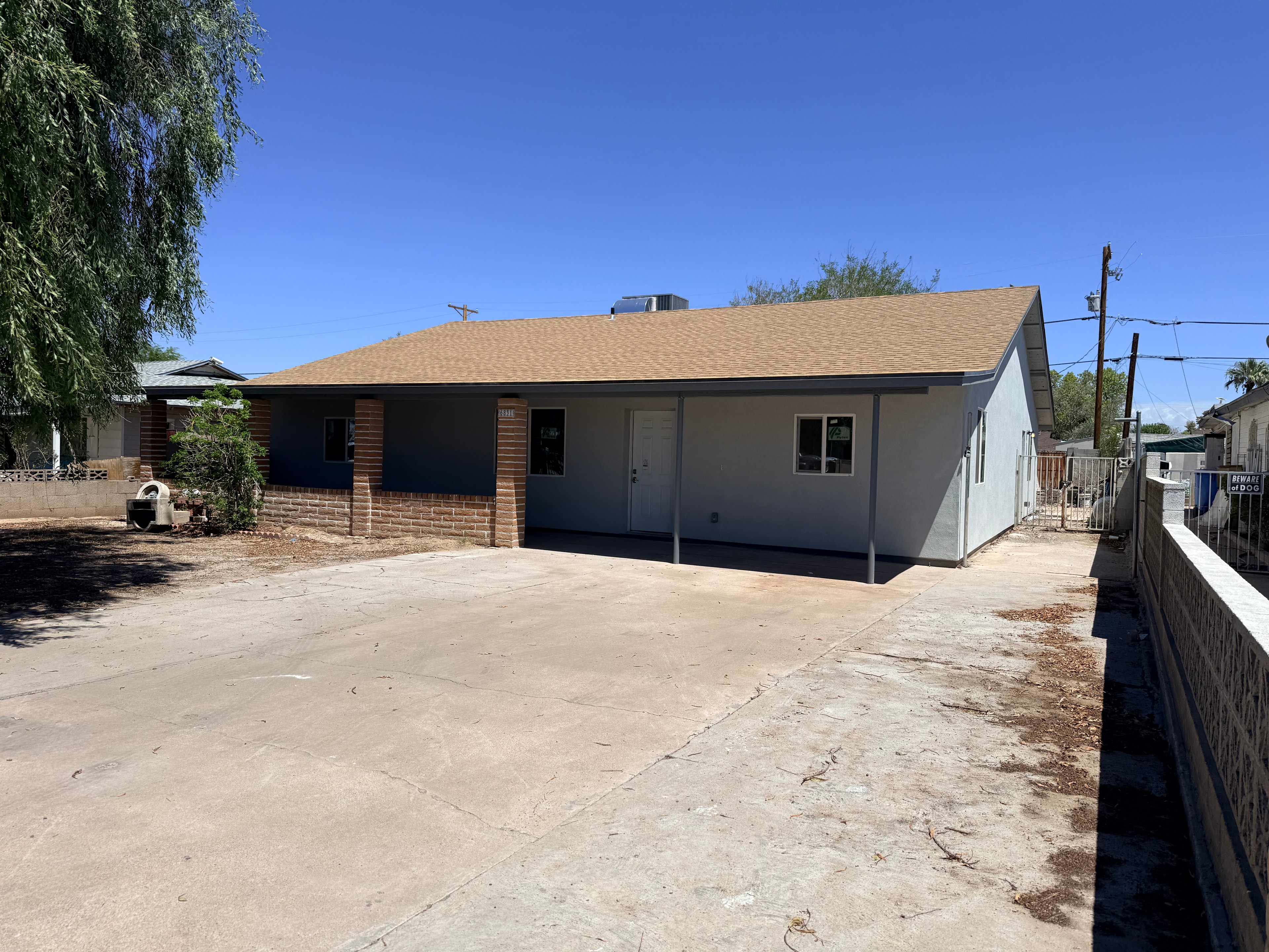 Restored residential exterior with new roof and fresh paint