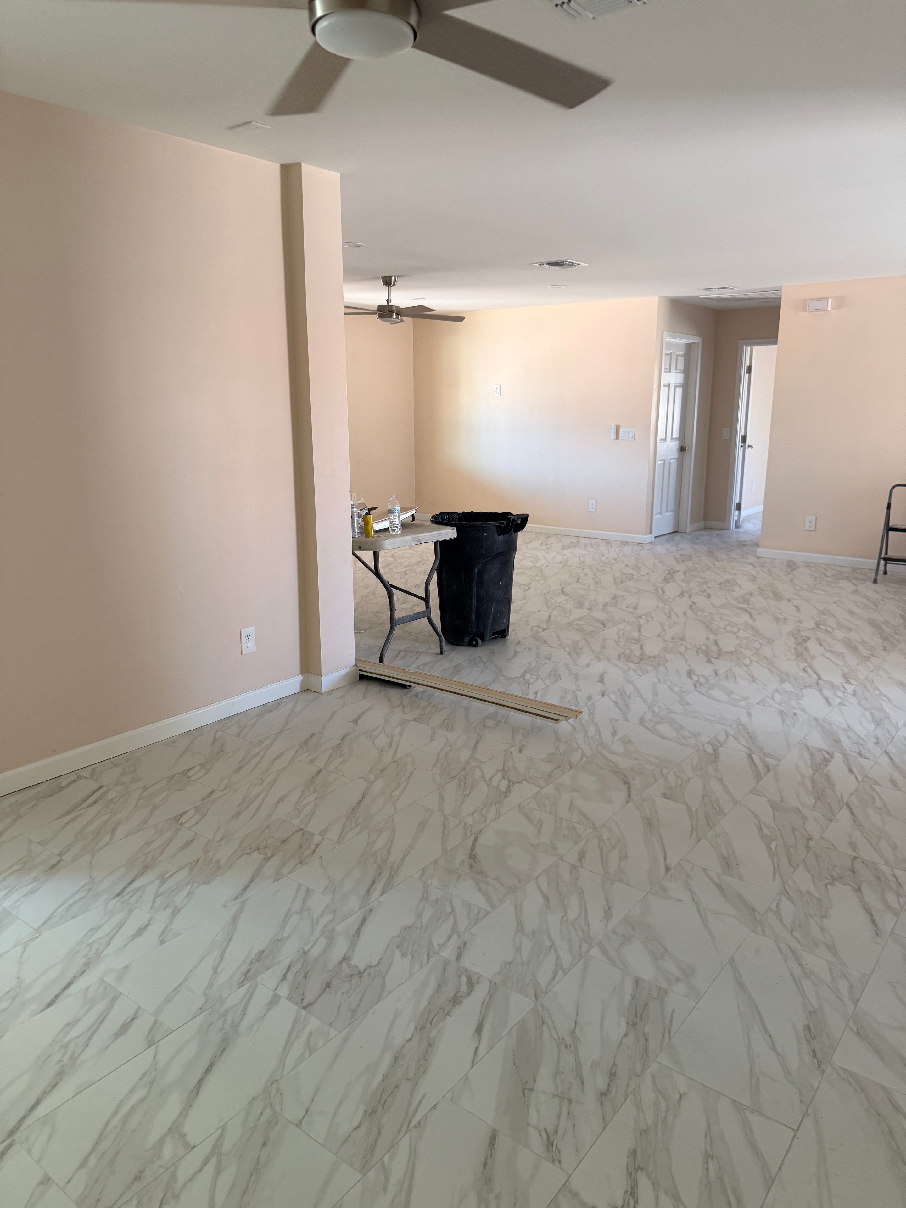 Interior renovation with marble tile walls and open floor plan