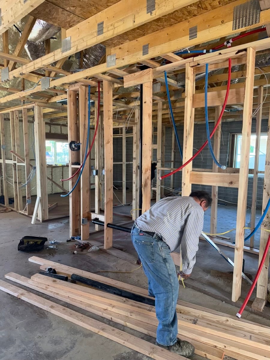 Construction worker installing electrical wiring — RMSERVCORP project