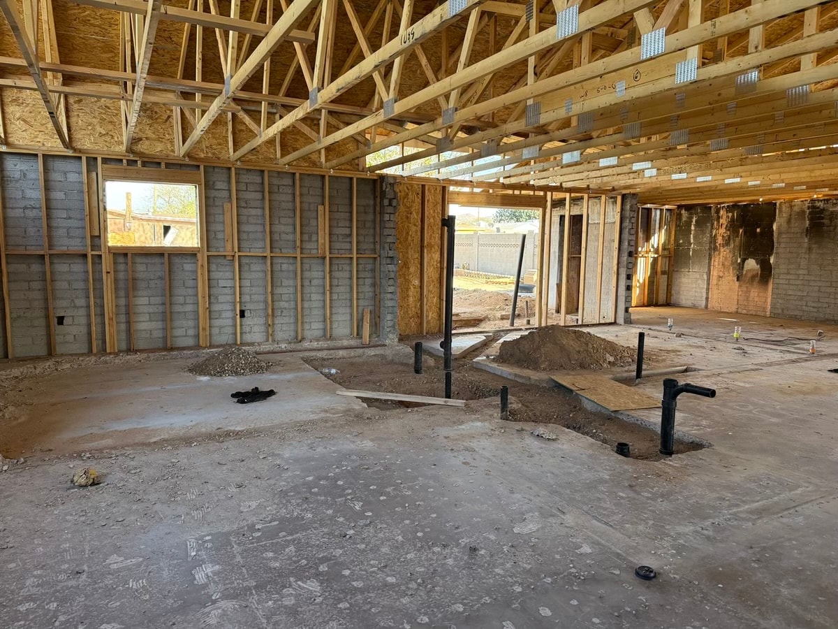 Unfinished house interior framing — RMSERVCORP restoration in progress