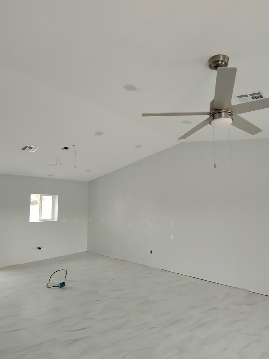 Empty room under construction with ceiling fan — RMSERVCORP restoration